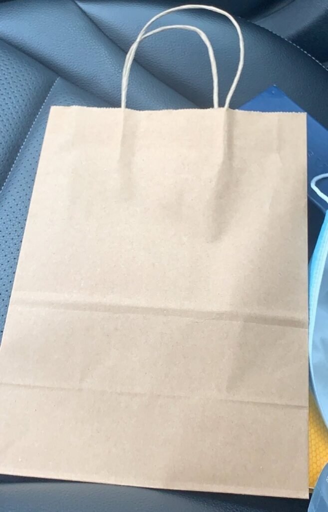 The plain brown bag that our weed gifts from LOCAL'd delivery service came in
